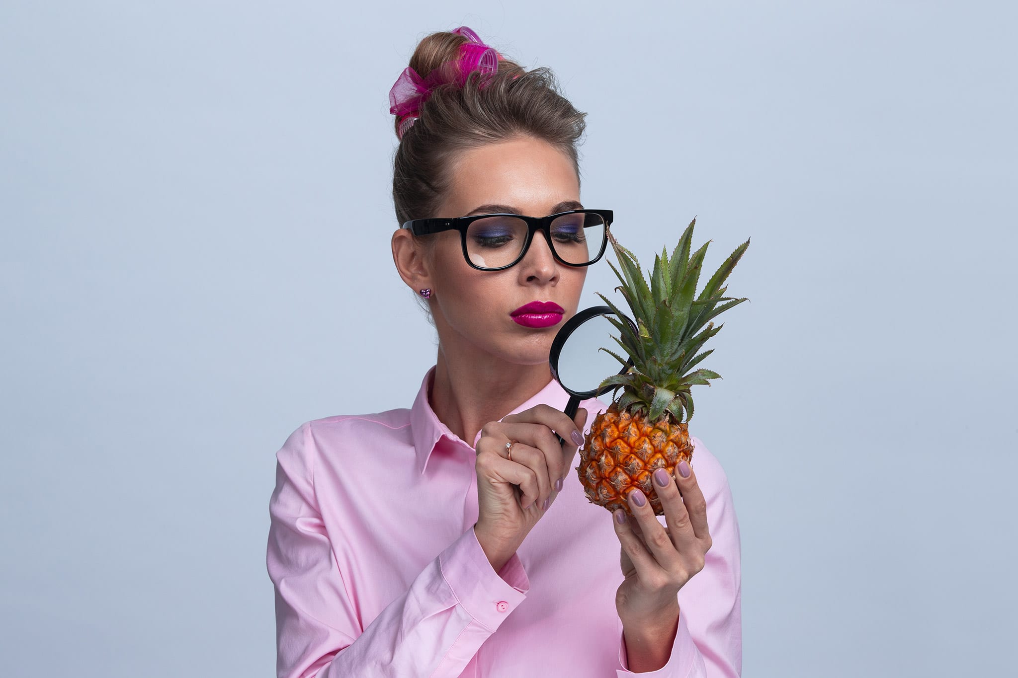 Woman inspecting a pineapple